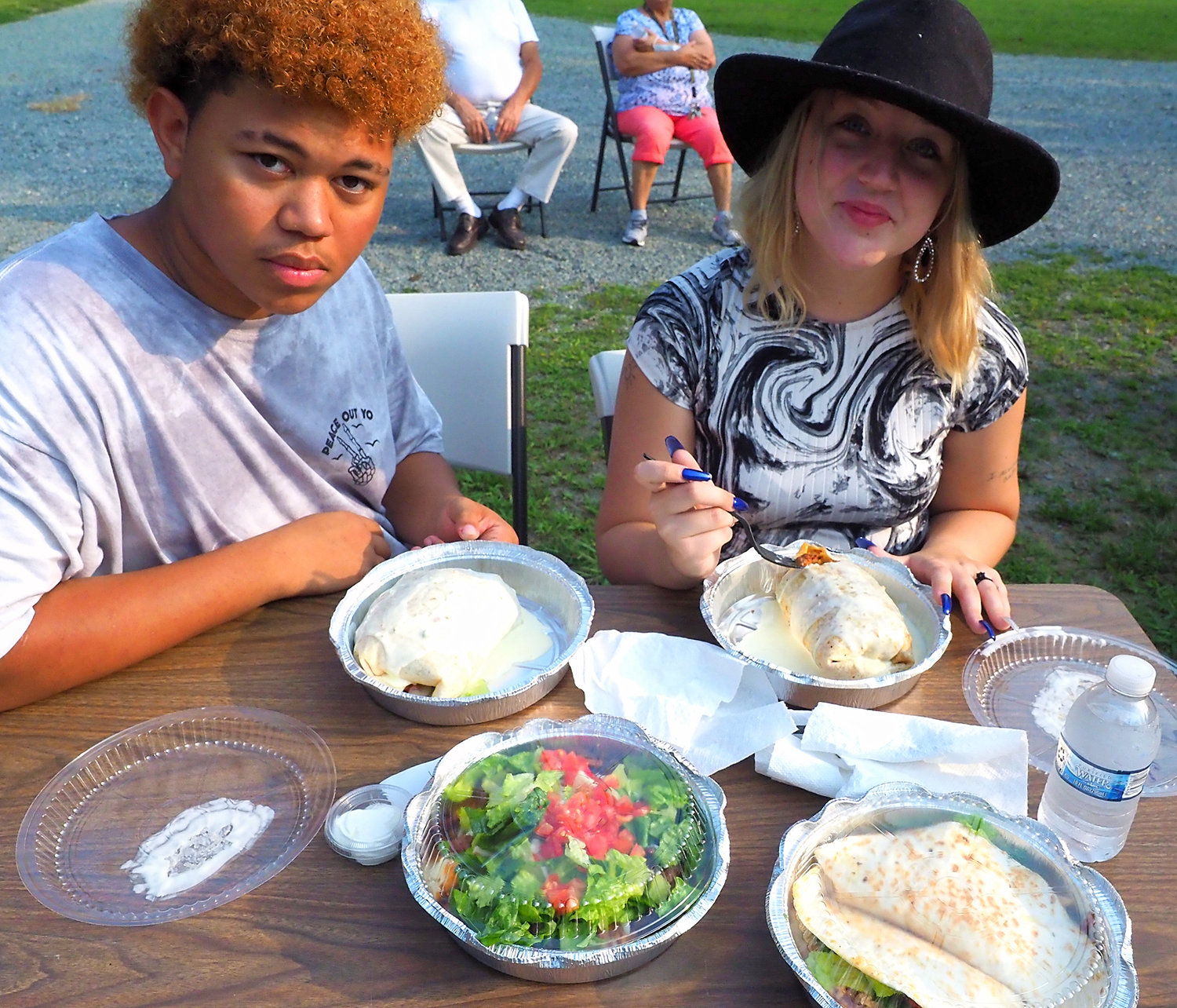 Ja'voh Ingram of Bladen County and LeAnne Gross of Sanford enjoy their Ta Contento entrees last Saturday at Cedar Grove UMC's 'summer fiesta' in Pittsboro.